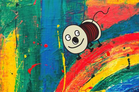 Piirretty Rulla-hahmo seisoo maalatun sateenkaaren päällä.