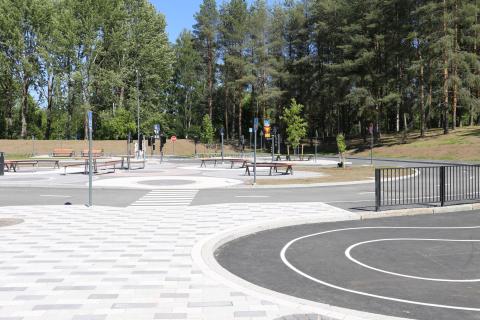 Liikennepuiston ajoradat ja liikennemerkkejä, taustalla puistomaisema.