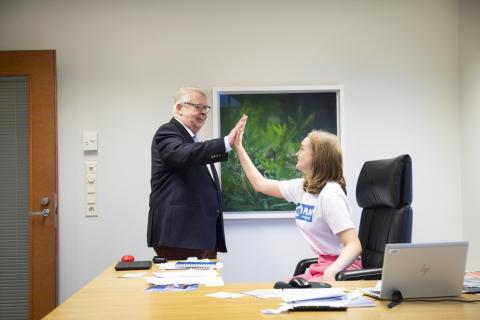Kalervo Kummola and Pauliina Mannerhovi high five together.