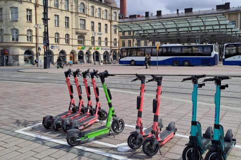 Electric scooters lined up in the electric scooter parking grid.