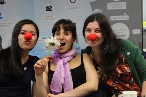 Three people with red noses posing together.