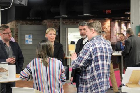 Group of people standing and talking.