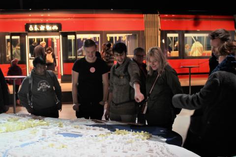A group of people studying a tram map.