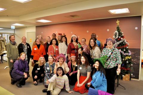 Group of Tampere ambassadors posing together in a Christmas atmosphere.