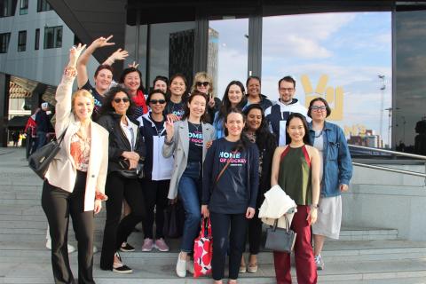 Group of people standing on stairs and posing together.
