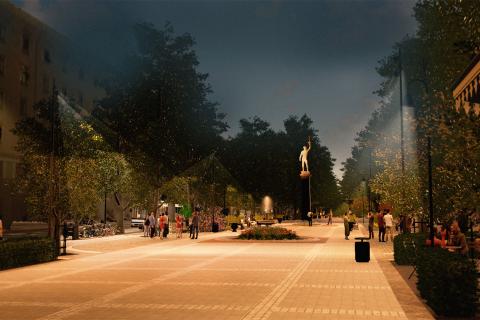 Iltakuva Hämeenpuiston aukiosta, valaistusta, patsas.