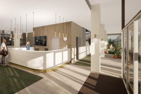 Havainnekuvassa on valkoinen infotiski, jonka edessä on asiakas ja takana työntekijä. Ikkunoiden valo heijastuu lattiaan ja tiskiin.