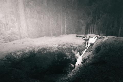 Lapsi ojentaa toiselle kuoppaan pudonneelle lapselle auttavan käden.